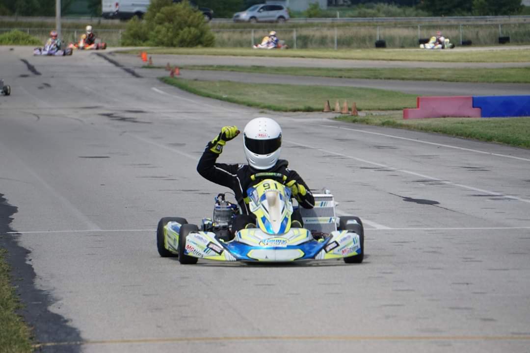 David Galownia taking a win, fist raised on track